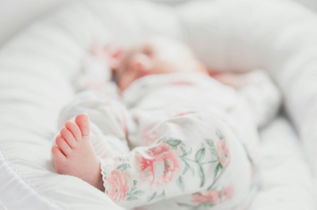 Kinderwunschtherapie Chemnitz: Ein Baby liegt in seinem Bettchen und schläft.